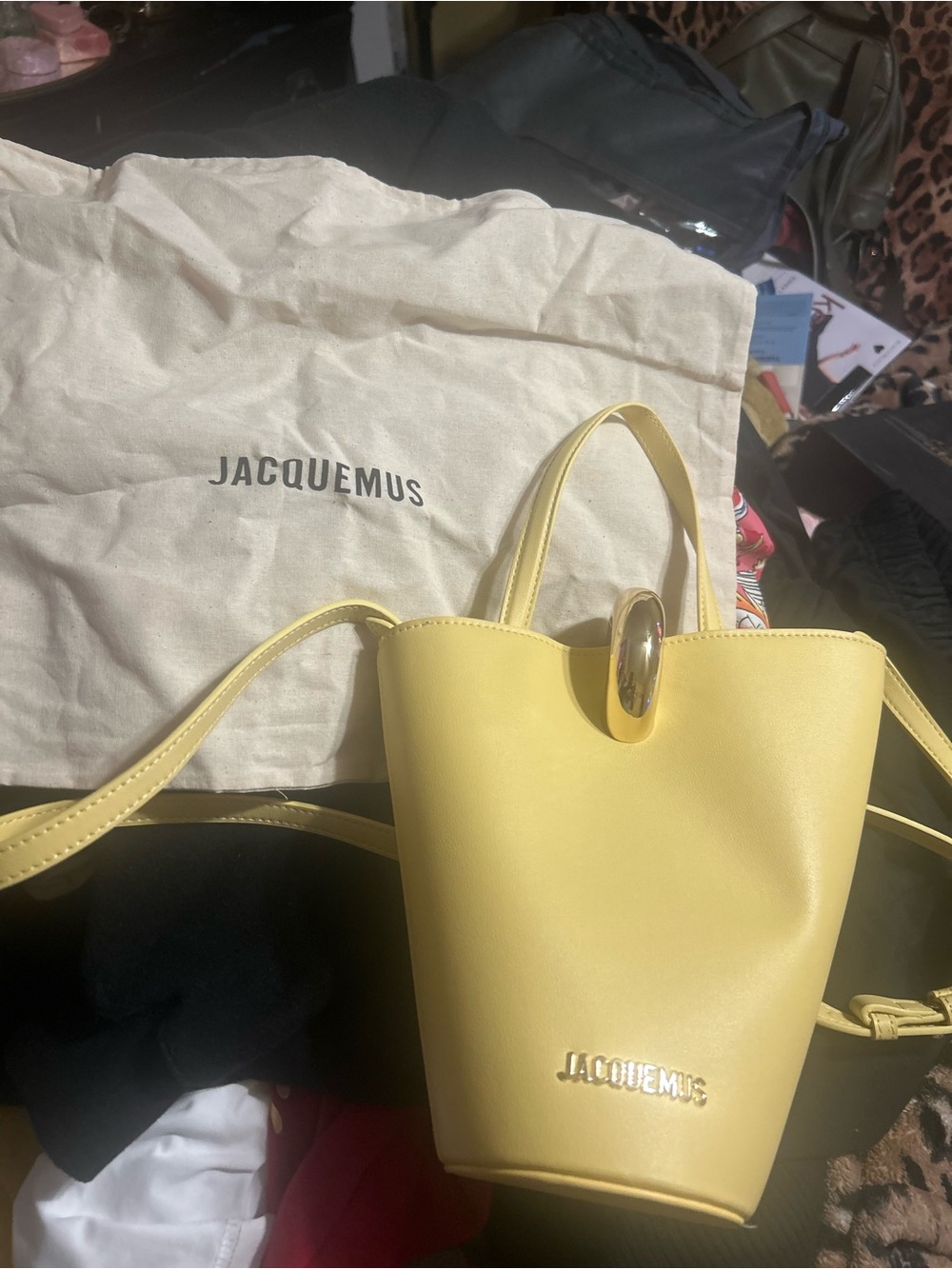 Jacquemus pastel yellow mini leather bucket bag with oval clasp